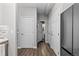 Hallway showcasing wood floors, neutral walls, and access to various rooms, including the kitchen and bathrooms at 9758 Laredo St # 18D, Commerce City, CO 80022