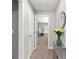 Hallway entrance with carpet flooring and a view into a bedroom at 9758 Laredo St # 18D, Commerce City, CO 80022