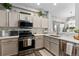 Bright kitchen features stainless steel appliances, granite countertops, tile backsplash, and light-colored cabinets at 9758 Laredo St # 18D, Commerce City, CO 80022