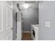 Laundry room features shelving, washer, dryer, and neutral paint at 9758 Laredo St # 18D, Commerce City, CO 80022