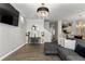 Open concept living area with hardwood floors, comfortable seating, and view into the kitchen and dining area at 9758 Laredo St # 18D, Commerce City, CO 80022