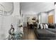 Open-concept living room with wood floors, modern decor, and a dining area featuring a large ornate mirror at 9758 Laredo St # 18D, Commerce City, CO 80022