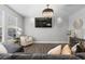 Bright living room with hardwood floors, large windows, modern light fixture, and stylish decor at 9758 Laredo St # 18D, Commerce City, CO 80022