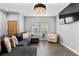 Spacious living room with hardwood floors, large sectional sofa, and windows offering natural light at 9758 Laredo St # 18D, Commerce City, CO 80022