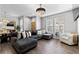 Living room with a plush sectional sofa, hardwood floors, and contemporary decor with natural light at 9758 Laredo St # 18D, Commerce City, CO 80022