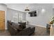 Comfortable living room with large windows, sleek TV, and hardwood floors creates an inviting space at 9758 Laredo St # 18D, Commerce City, CO 80022