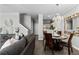 Open floor plan of living room and dining area with stylish decor, hardwood floors, and access to the kitchen at 9758 Laredo St # 18D, Commerce City, CO 80022