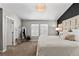 Elegant main bedroom features neutral walls, a crystal chandelier, and a luxurious upholstered headboard and plush bedding at 9758 Laredo St # 18D, Commerce City, CO 80022