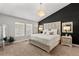 This main bedroom is bright and spacious with large windows, a crystal chandelier, and a luxurious upholstered headboard at 9758 Laredo St # 18D, Commerce City, CO 80022