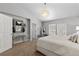 Spacious main bedroom with crystal chandelier, ensuite bathroom, and vanity with decorative mirror at 9758 Laredo St # 18D, Commerce City, CO 80022