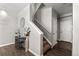 Entryway staircase with carpeted steps, white railing, and decor including vases and artwork at 9758 Laredo St # 18D, Commerce City, CO 80022