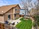 Aerial view of a spacious backyard with patio, lush lawn, and privacy fencing at 12552 Tammywood St, Broomfield, CO 80020