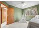 Bedroom includes green walls, carpeted floors, closet, and natural light from the window at 12552 Tammywood St, Broomfield, CO 80020