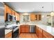 Modern kitchen featuring stainless steel appliances, bright countertops, and wooden cabinetry at 12552 Tammywood St, Broomfield, CO 80020