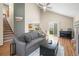 Open-concept living room featuring vaulted ceilings, hardwood floors, and a cozy seating area at 12552 Tammywood St, Broomfield, CO 80020