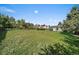 A large backyard featuring lush grass, a wooden fence, and the home's gray siding, providing a serene outdoor space at 1043 Lilac Ct, Broomfield, CO 80020