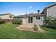 Backyard featuring a patio, a side entrance door, and lush green grass, perfect for outdoor activities at 1043 Lilac Ct, Broomfield, CO 80020