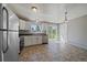 Well-lit kitchen with stainless steel appliances, white cabinets, tile flooring, and sliding glass doors at 1043 Lilac Ct, Broomfield, CO 80020