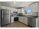 Well-lit kitchen with stainless steel appliances and white cabinets with plenty of counter space at 1043 Lilac Ct, Broomfield, CO 80020