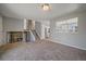 Spacious living room featuring a fireplace, stairs to the upper floor, and a pass-through to the kitchen at 1043 Lilac Ct, Broomfield, CO 80020