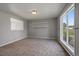 Bright living room with neutral walls and carpeting and a large window offering natural light at 1043 Lilac Ct, Broomfield, CO 80020