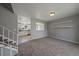 Cozy living room featuring neutral carpeting, open view to kitchen and stairs leading to the second floor at 1043 Lilac Ct, Broomfield, CO 80020