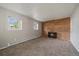 Living room with brick fireplace, plush carpet, neutral walls, and natural light streaming in from the windows at 1043 Lilac Ct, Broomfield, CO 80020
