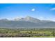 Stunning mountain views overlooking the city, with lush green fields in the foreground at 1043 Lilac Ct, Broomfield, CO 80020