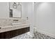 Powder bathroom with a vessel sink, stone counter, and patterned tile flooring at 2475 S Saint Paul St, Denver, CO 80210