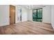 Bedroom featuring hardwood floors, a large window with natural light, and ensuite bathroom at 2475 S Saint Paul St, Denver, CO 80210