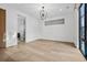 Open and airy bedroom with wood floors, modern light fixture and an en suite bathroom at 2475 S Saint Paul St, Denver, CO 80210