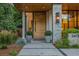 Elegant front entrance featuring a modern wood door, stone accents, and stylish planters at 2475 S Saint Paul St, Denver, CO 80210