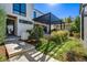 Beautiful modern house with front yard and steps to an outdoor kitchen and dining area at 2475 S Saint Paul St, Denver, CO 80210