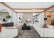 Bright open-concept living room with stone fireplace, wooden beam ceilings, and expansive sectional sofa at 2475 S Saint Paul St, Denver, CO 80210