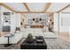 Comfortable living room with white sectional sofa, wooden beams, and open floor plan to kitchen at 2475 S Saint Paul St, Denver, CO 80210