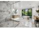 Spacious bathroom featuring marble shower, soaking tub, dual vanities, and large window at 2475 S Saint Paul St, Denver, CO 80210