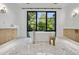 Bright, spacious bathroom with modern soaking tub, large window, and dual sink vanities at 2475 S Saint Paul St, Denver, CO 80210