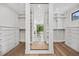 Spacious walk-in closet with hardwood floors, large mirror, and ample storage space at 2475 S Saint Paul St, Denver, CO 80210