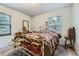 Cozy bedroom with two windows offering natural light, featuring a charming decorative bed frame at 10040 W 13Th Pl, Lakewood, CO 80215