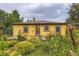 Charming home featuring yellow siding, a cozy front yard, and a quaint garden area at 10040 W 13Th Pl, Lakewood, CO 80215