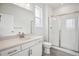 Modern bathroom featuring a single sink vanity and a glass-enclosed shower at 8245 Butte Creek St, Littleton, CO 80125