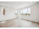 Bright primary bedroom features three windows with mountain views and wood-look floors at 8245 Butte Creek St, Littleton, CO 80125