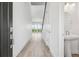 Bright entryway featuring wood floors, white walls, a powder room, and an open view of the backyard at 8245 Butte Creek St, Littleton, CO 80125