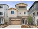 Beautiful multi-story home featuring mixed siding and stone accents, a two-car garage, and a covered patio at 8245 Butte Creek St, Littleton, CO 80125