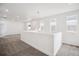 Bright, spacious hallway featuring modern lighting and neutral carpet flooring at 8245 Butte Creek St, Littleton, CO 80125