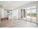 Open living area with wood floors, a modern kitchen, and sliding glass doors to a fenced patio at 8245 Butte Creek St, Littleton, CO 80125