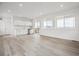Bright living room with a wet bar, modern cabinetry, and sliding glass doors to a balcony at 8245 Butte Creek St, Littleton, CO 80125