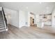 Open-concept floor plan with a staircase leading to the upper level, wood floors, and a modern kitchen at 8245 Butte Creek St, Littleton, CO 80125