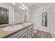 Well-lit bathroom with dual sinks, a large mirror, and a tiled shower/tub combo exudes cleanliness and style at 17271 Waterhouse Cir # A, Parker, CO 80134