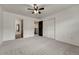 Large bedroom with ceiling fan, plush carpeting, closet, and en-suite bath offers comfort and convenience at 17271 Waterhouse Cir # A, Parker, CO 80134